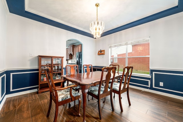9619 Whittington Park Ln, Houston, TX 77095 - dining room featuring ornamental molding, arched walkways, wainscoting, a raised ceiling, and a chandelier