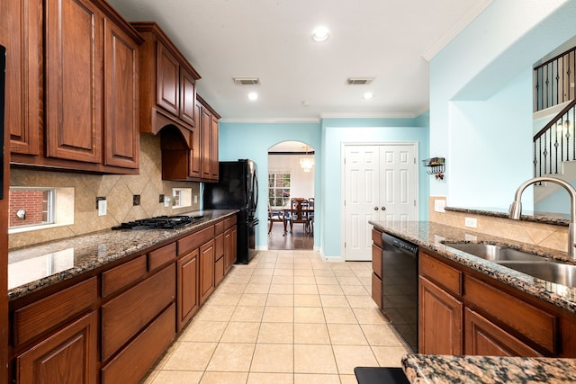 9619 Whittington Park Ln, Houston, TX 77095 - kitchen with black appliances, a sink, arched walkways, light tile patterned floors, and tasteful backsplash