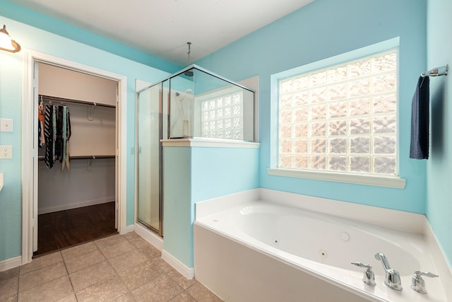 9619 Whittington Park Ln, Houston, TX 77095 - bathroom with a shower stall, a whirlpool tub, a spacious closet, tile patterned floors, and baseboards