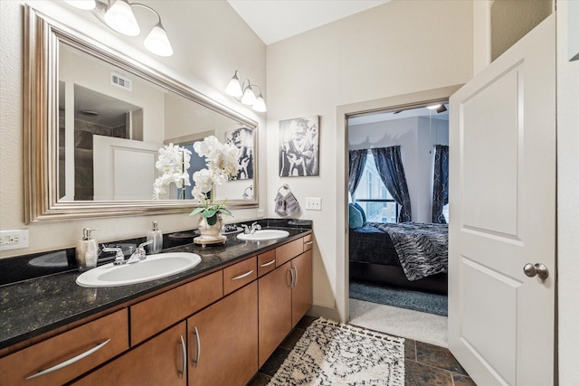 full bathroom featuring double vanity and ensuite bath