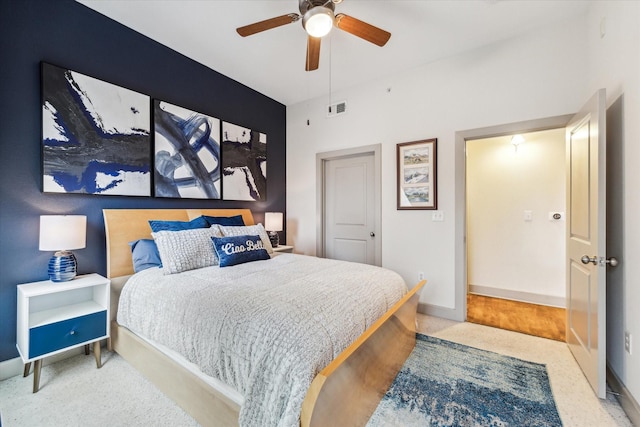 carpeted bedroom featuring baseboards and ceiling fan
