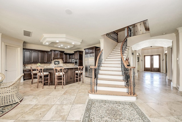 5701 Sugar Hill Dr, Houston, TX 77057 - entryway with arched walkways, stairway, ornamental molding, french doors, and recessed lighting