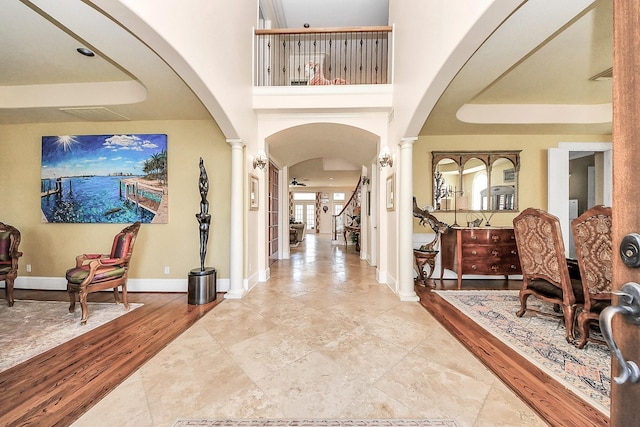 5701 Sugar Hill Dr, Houston, TX 77057 - foyer entrance featuring ornate columns, arched walkways, and baseboards