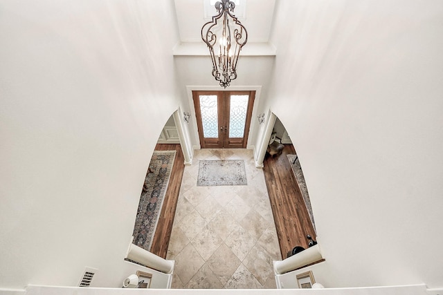 5701 Sugar Hill Dr, Houston, TX 77057 - entryway featuring a towering ceiling, arched walkways, french doors, and a chandelier