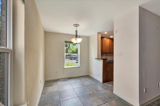 411 Westmoreland St Unit 1, Houston, TX 77006 - unfurnished dining area featuring baseboards, light tile patterned floors, and recessed lighting