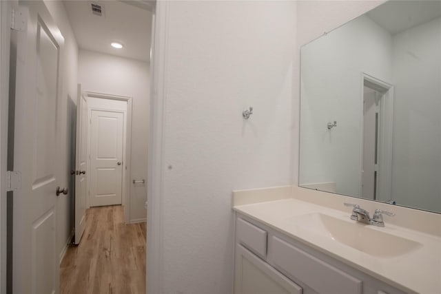 22065 Juniper Crossing Dr, New Caney, TX 77357 - bathroom featuring wood finished floors, vanity, and recessed lighting