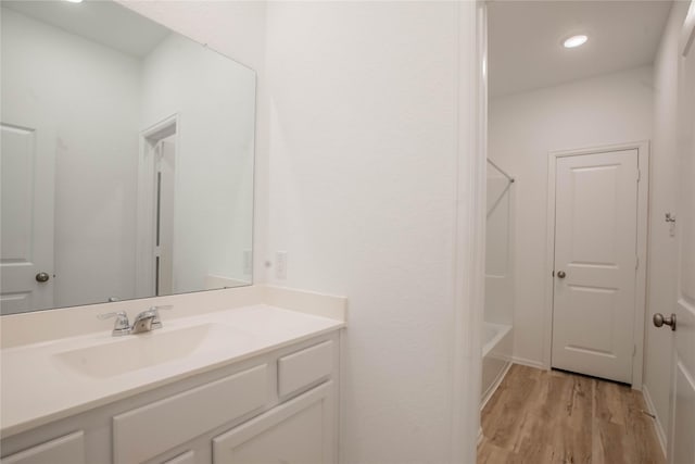 22065 Juniper Crossing Dr, New Caney, TX 77357 - bathroom featuring vanity, wood finished floors, recessed lighting, and shower / tub combination