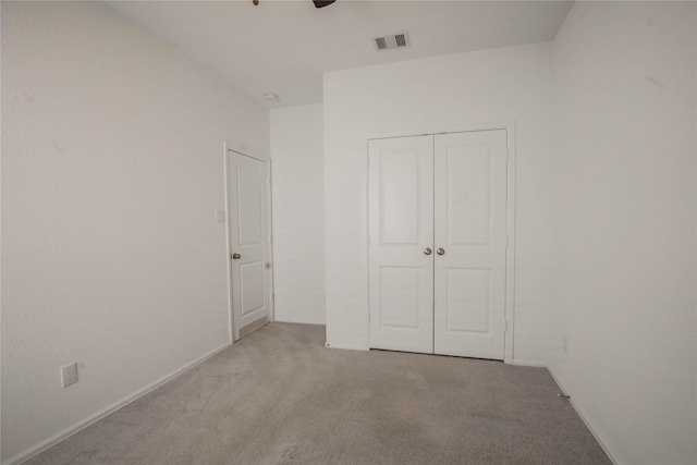22065 Juniper Crossing Dr, New Caney, TX 77357 - unfurnished bedroom featuring carpet floors, a closet, baseboards, and a ceiling fan