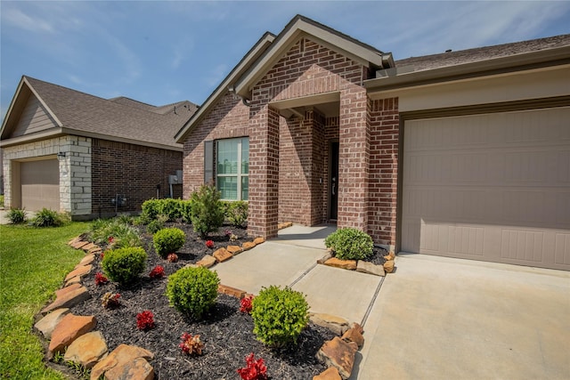 22065 Juniper Crossing Dr, New Caney, TX 77357 - view of front facade featuring brick siding, a garage, and driveway