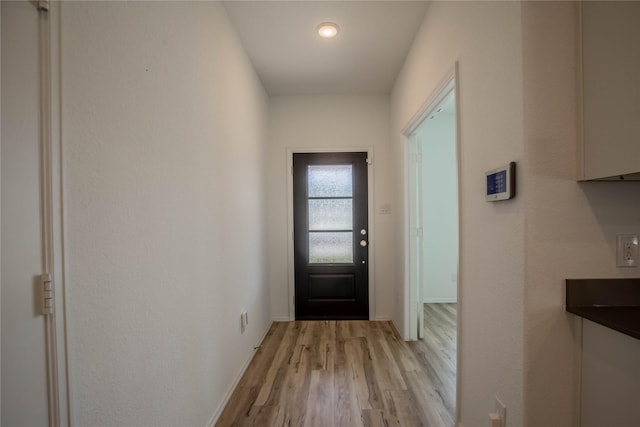 22065 Juniper Crossing Dr, New Caney, TX 77357 - doorway to outside featuring light wood-style flooring and baseboards