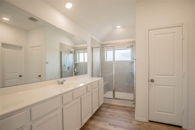 22065 Juniper Crossing Dr, New Caney, TX 77357 - bathroom with a shower stall, lofted ceiling, wood finished floors, vanity, and recessed lighting