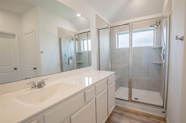 22065 Juniper Crossing Dr, New Caney, TX 77357 - full bath featuring vaulted ceiling, a shower stall, wood finished floors, and vanity