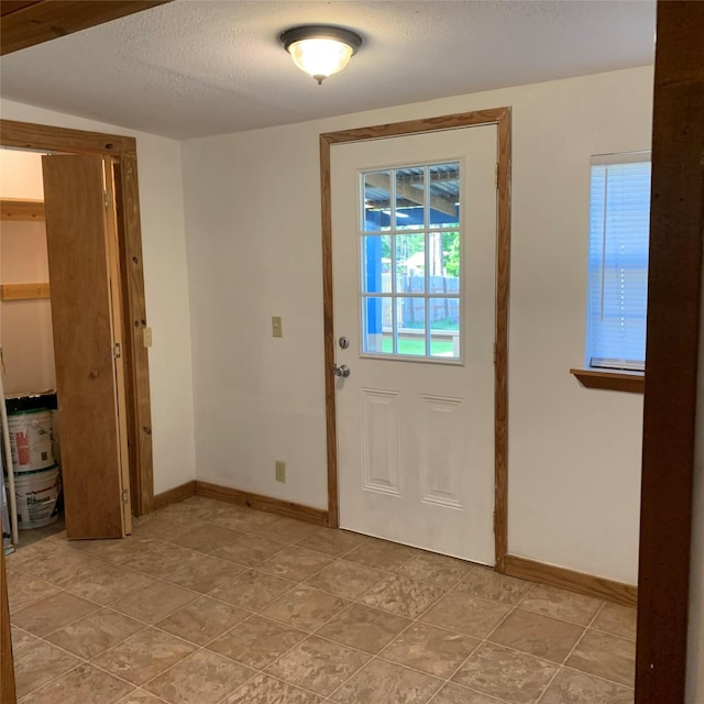 324 Persimmon Rd, Onalaska, TX 77360 - entryway with baseboards and a textured ceiling