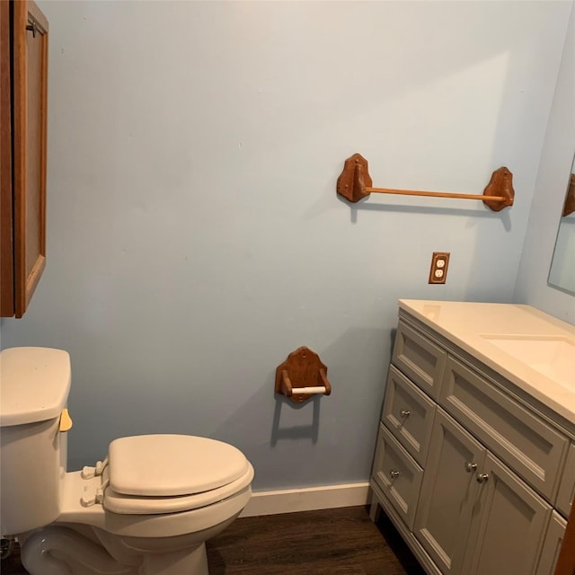 324 Persimmon Rd, Onalaska, TX 77360 - half bath featuring wood finished floors, vanity, toilet, and baseboards