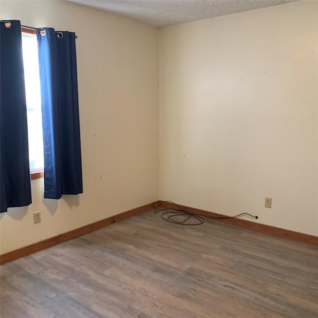 324 Persimmon Rd, Onalaska, TX 77360 - unfurnished room featuring wood finished floors and baseboards