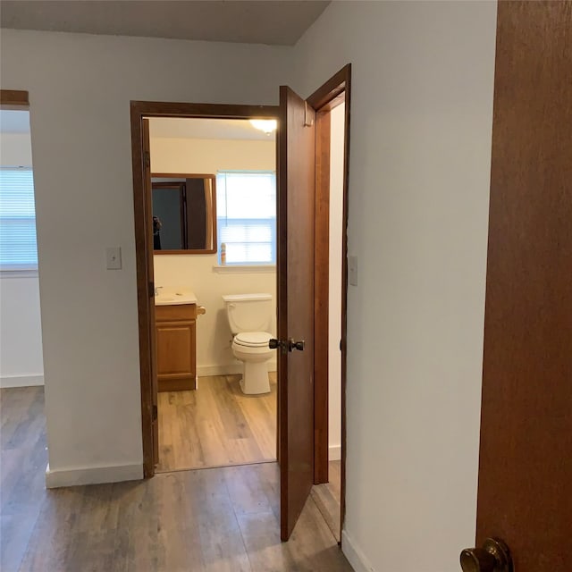 324 Persimmon Rd, Onalaska, TX 77360 - bathroom with wood finished floors, toilet, vanity, and baseboards