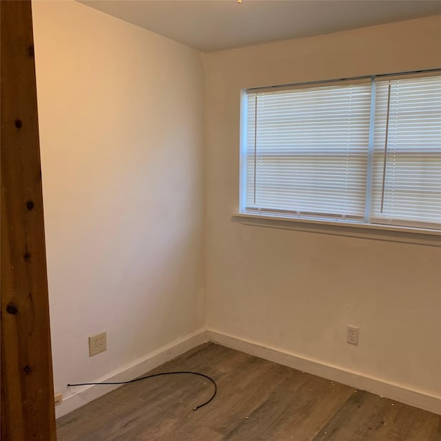 324 Persimmon Rd, Onalaska, TX 77360 - spare room featuring dark wood-type flooring and baseboards