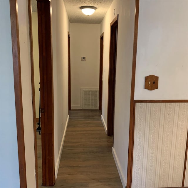 324 Persimmon Rd, Onalaska, TX 77360 - hall with dark wood-style flooring, a textured ceiling, and baseboards