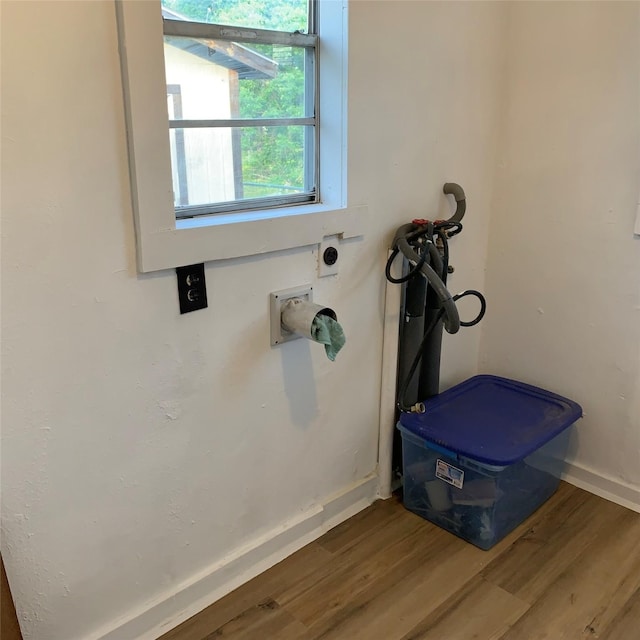 324 Persimmon Rd, Onalaska, TX 77360 - laundry view of wood finished floors and baseboards
