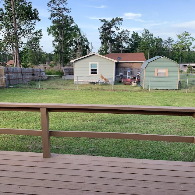 324 Persimmon Rd, Onalaska, TX 77360 - view of yard featuring a wooden deck, a storage shed, and an outbuilding