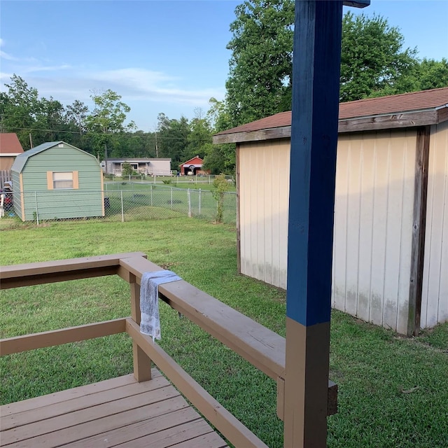 324 Persimmon Rd, Onalaska, TX 77360 - view of yard with a storage unit, an outdoor structure, and a wooden deck