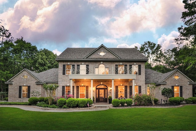 711 Valley Commons Dr, Huffman, TX 77336 - colonial home featuring brick siding and a front lawn