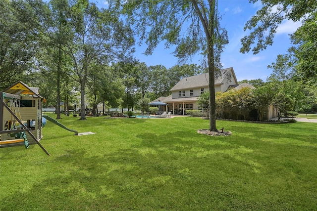 711 Valley Commons Dr, Huffman, TX 77336 - view of green lawn with a playground and an outdoor pool