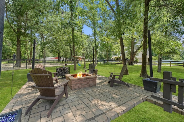 711 Valley Commons Dr, Huffman, TX 77336 - view of patio with an outdoor fire pit