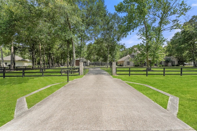711 Valley Commons Dr, Huffman, TX 77336 - view of concrete surface with a gate and a gated entry