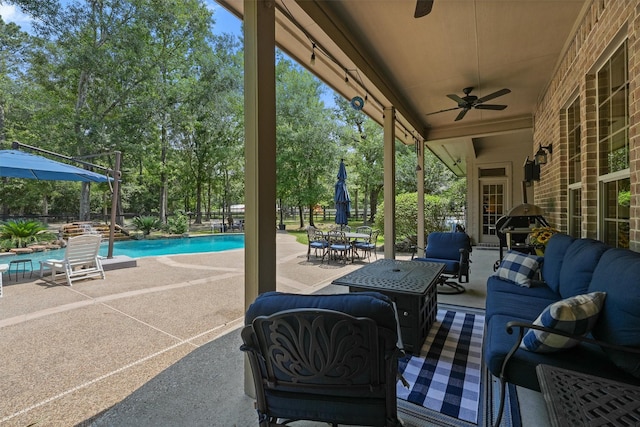 711 Valley Commons Dr, Huffman, TX 77336 - view of patio / terrace with outdoor lounge area, ceiling fan, an outdoor pool, and view of wooded area