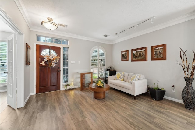 17150 Mountain Crest Dr, Spring, TX 77379 - foyer with wood finished floors, crown molding, rail lighting, and baseboards