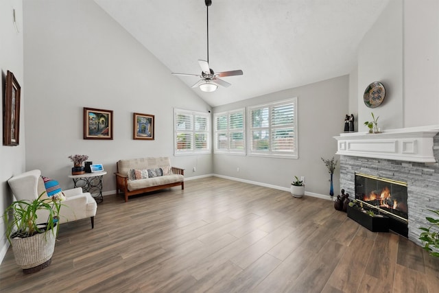 17150 Mountain Crest Dr, Spring, TX 77379 - living area with a stone fireplace, wood finished floors, a ceiling fan, baseboards, and high vaulted ceiling