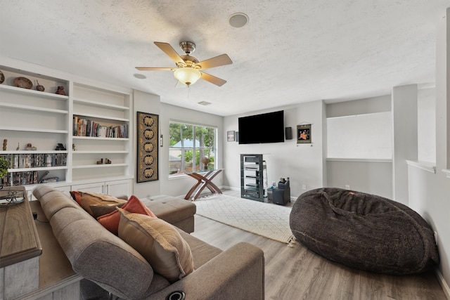17150 Mountain Crest Dr, Spring, TX 77379 - living area with a textured ceiling, wood finished floors, ceiling fan, and baseboards