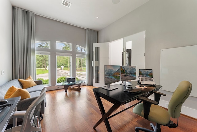 3214 W Benders Landing Blvd, Spring, TX 77386 - home office featuring a towering ceiling and light wood-style floors