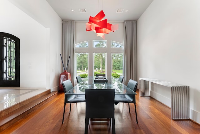 3214 W Benders Landing Blvd, Spring, TX 77386 - dining room with wood finished floors, a towering ceiling, and arched walkways