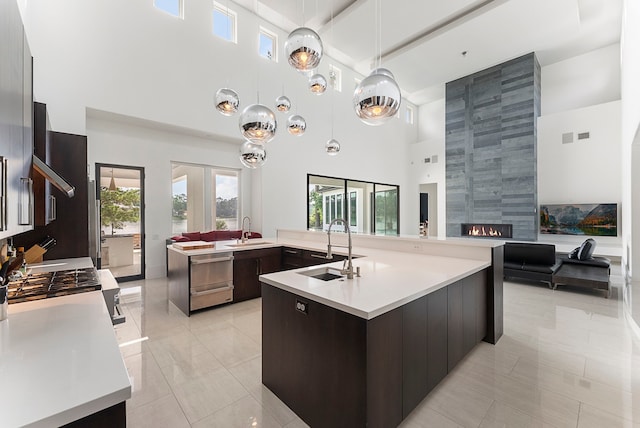 3214 W Benders Landing Blvd, Spring, TX 77386 - kitchen featuring a towering ceiling, modern cabinets, a sink, and beam ceiling