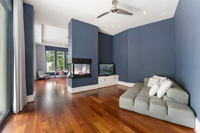 3214 W Benders Landing Blvd, Spring, TX 77386 - living room featuring a ceiling fan, a multi sided fireplace, and wood finished floors