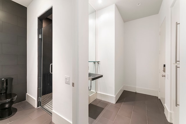 3214 W Benders Landing Blvd, Spring, TX 77386 - bathroom featuring a stall shower, toilet, tile patterned floors, and baseboards