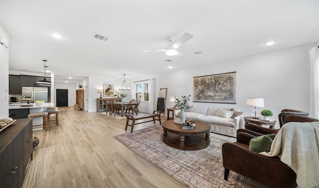 106 Kickapoo Dr, Anahuac, TX 77514 - living room with a ceiling fan, light wood-style flooring, recessed lighting, and a chandelier