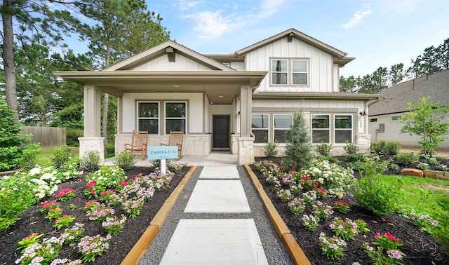 106 Kickapoo Dr, Anahuac, TX 77514 - view of front of property featuring covered porch, board and batten siding, and stone siding