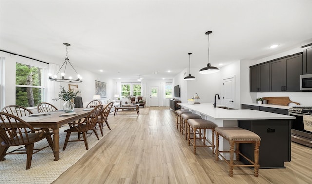 106 Kickapoo Dr, Anahuac, TX 77514 - dining space featuring light wood-type flooring, plenty of natural light, recessed lighting, and a chandelier