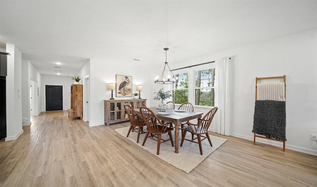 106 Kickapoo Dr, Anahuac, TX 77514 - dining space with light wood-type flooring, a chandelier, and baseboards