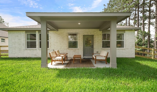 106 Kickapoo Dr, Anahuac, TX 77514 - back of house with brick siding and a patio area