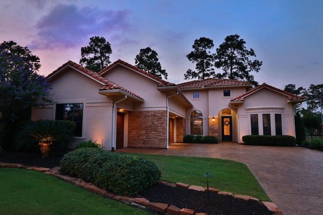 16114 Villa Fontana Way, Houston, TX 77068 - mediterranean / spanish-style house with stucco siding, a lawn, stone siding, curved driveway, and a tile roof