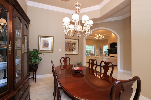 16114 Villa Fontana Way, Houston, TX 77068 - dining space with crown molding, arched walkways, a chandelier, light tile patterned floors, and a tray ceiling