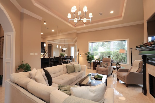16114 Villa Fontana Way, Houston, TX 77068 - living room featuring arched walkways, a raised ceiling, a chandelier, ornamental molding, and recessed lighting