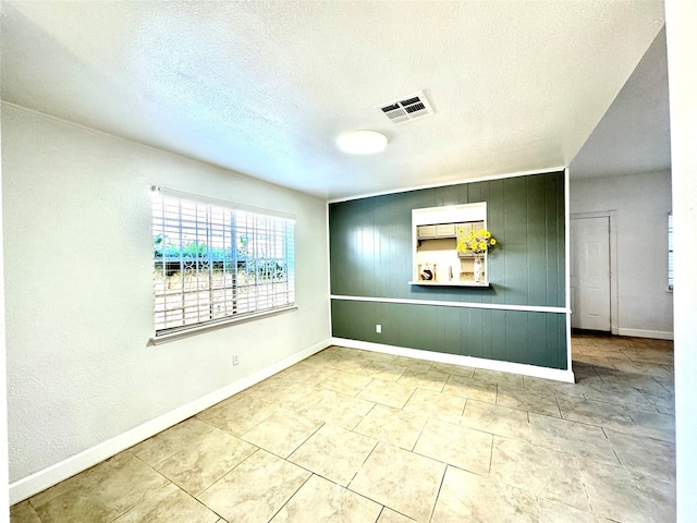 11127 Village Bend Ln Unit 1127, Houston, TX 77072 - spare room featuring baseboards, a textured ceiling, and light tile patterned floors