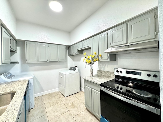 11127 Village Bend Ln Unit 1127, Houston, TX 77072 - kitchen with stainless steel electric range oven, washing machine and clothes dryer, under cabinet range hood, and gray cabinets