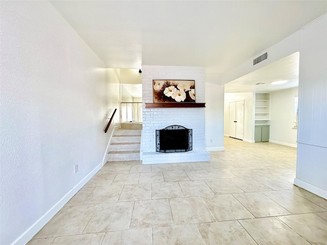 11127 Village Bend Ln Unit 1127, Houston, TX 77072 - unfurnished living room with baseboards, a fireplace, stairs, and built in features