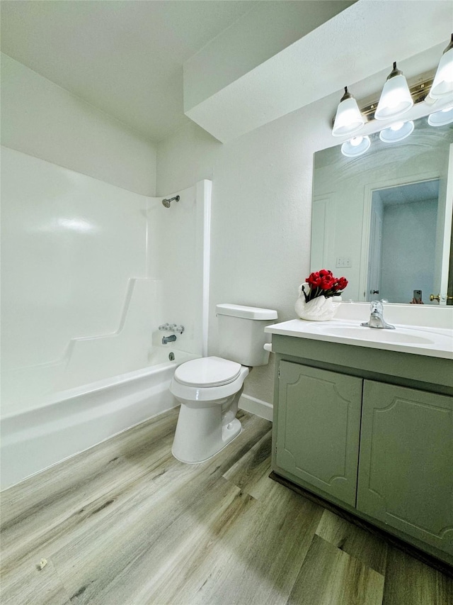 11127 Village Bend Ln Unit 1127, Houston, TX 77072 - full bathroom with wood finished floors, toilet, vanity, shower / bath combination, and baseboards